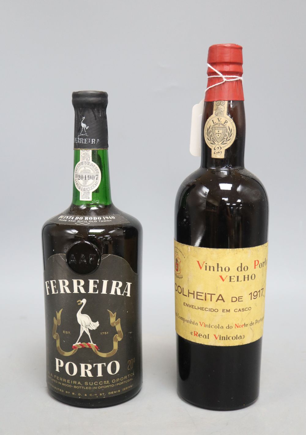A bottle of Ferreira Porto and one bottle of Vinho do Porto Velho Colheita De 1917